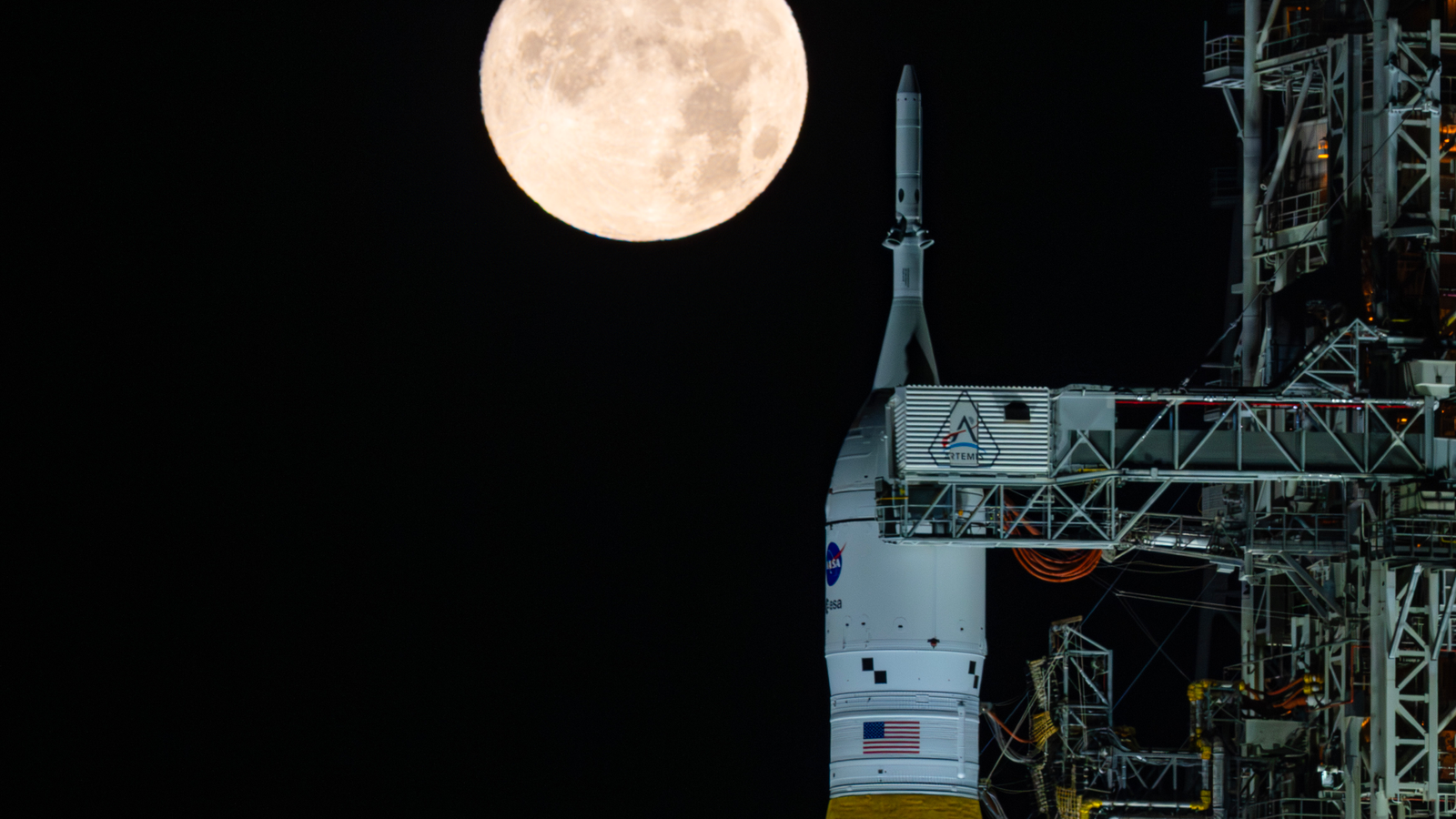 NASA’s Space Launch System and Orion at Launch Pad 39B under a full moon